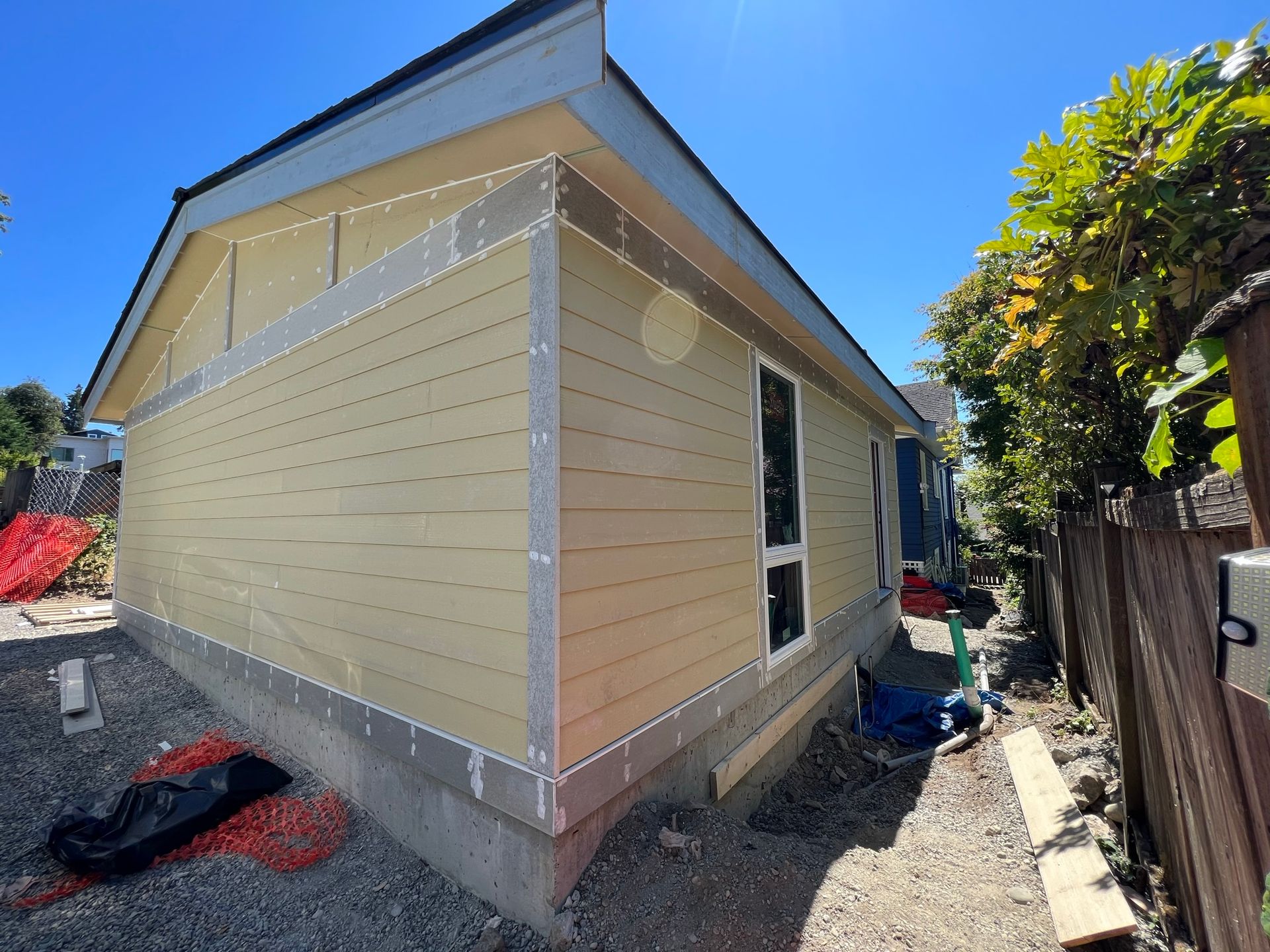 A house is being built with a fence in the background