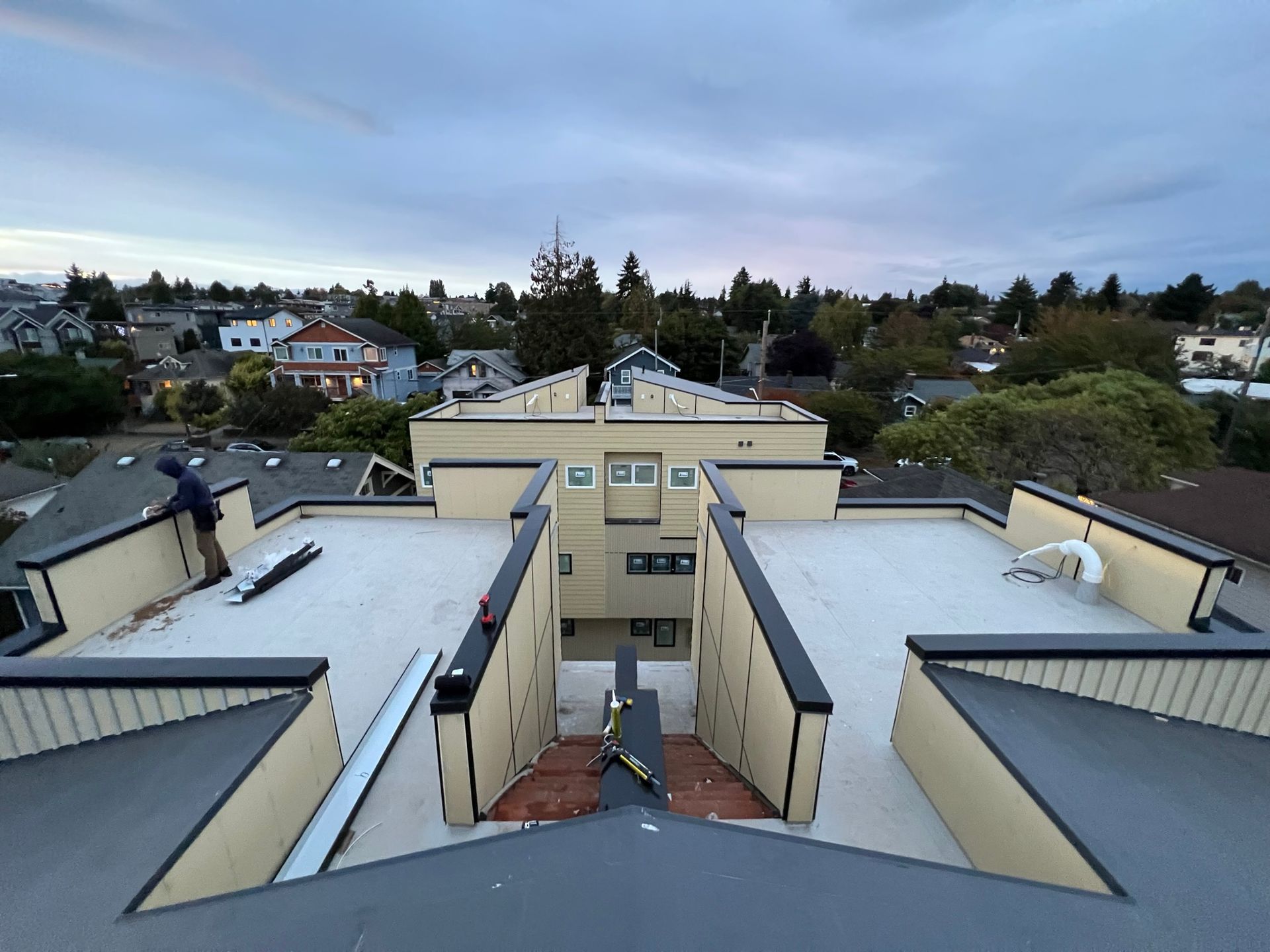A man is working on the roof of a building.