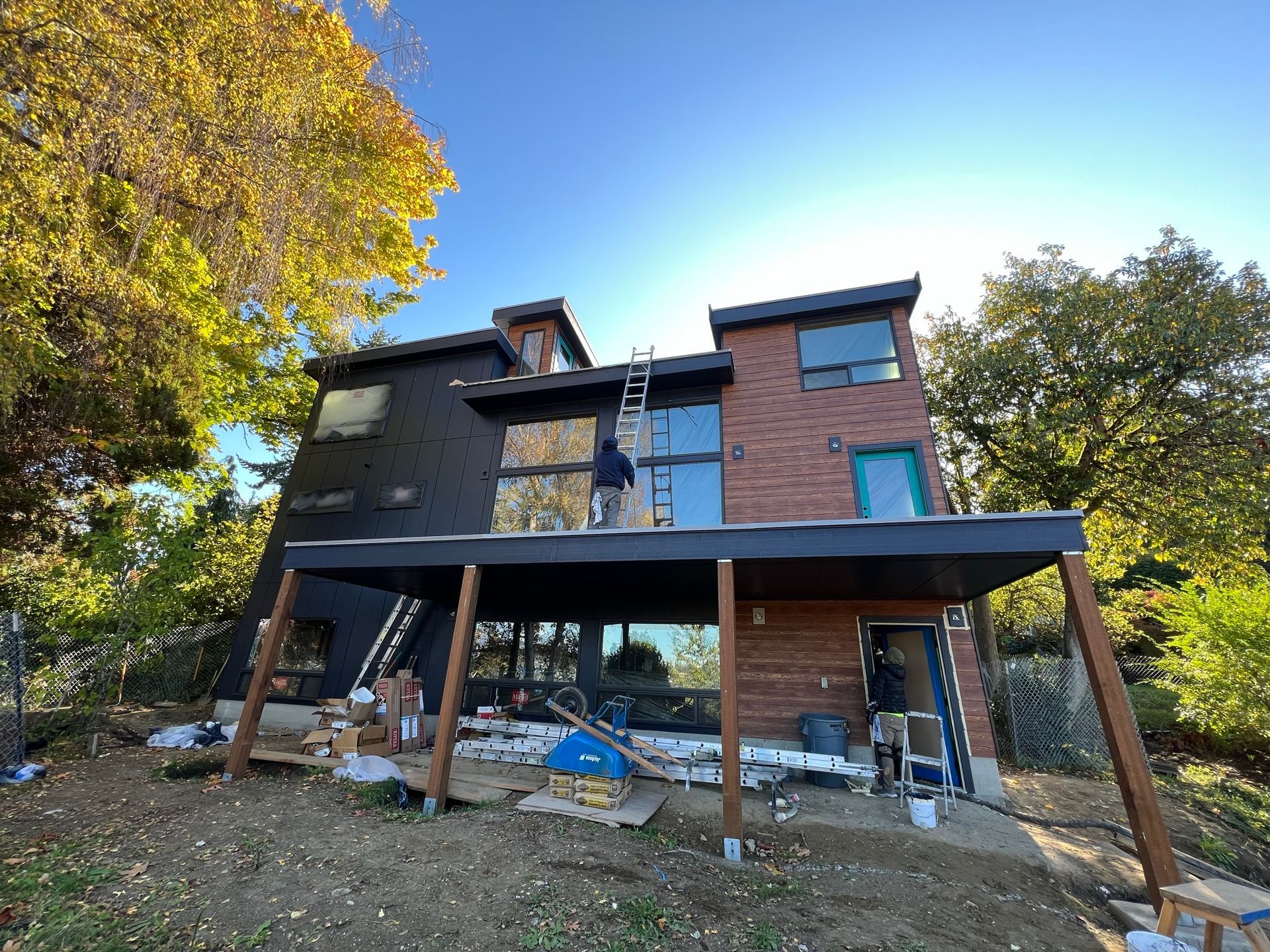 A man is painting the side of a house.