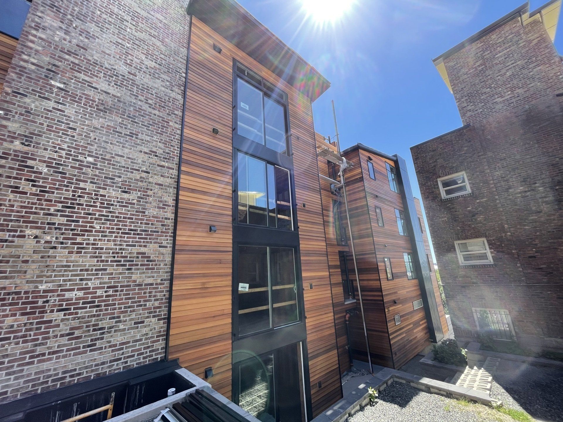 A brick building with a wooden facade and a lot of windows.