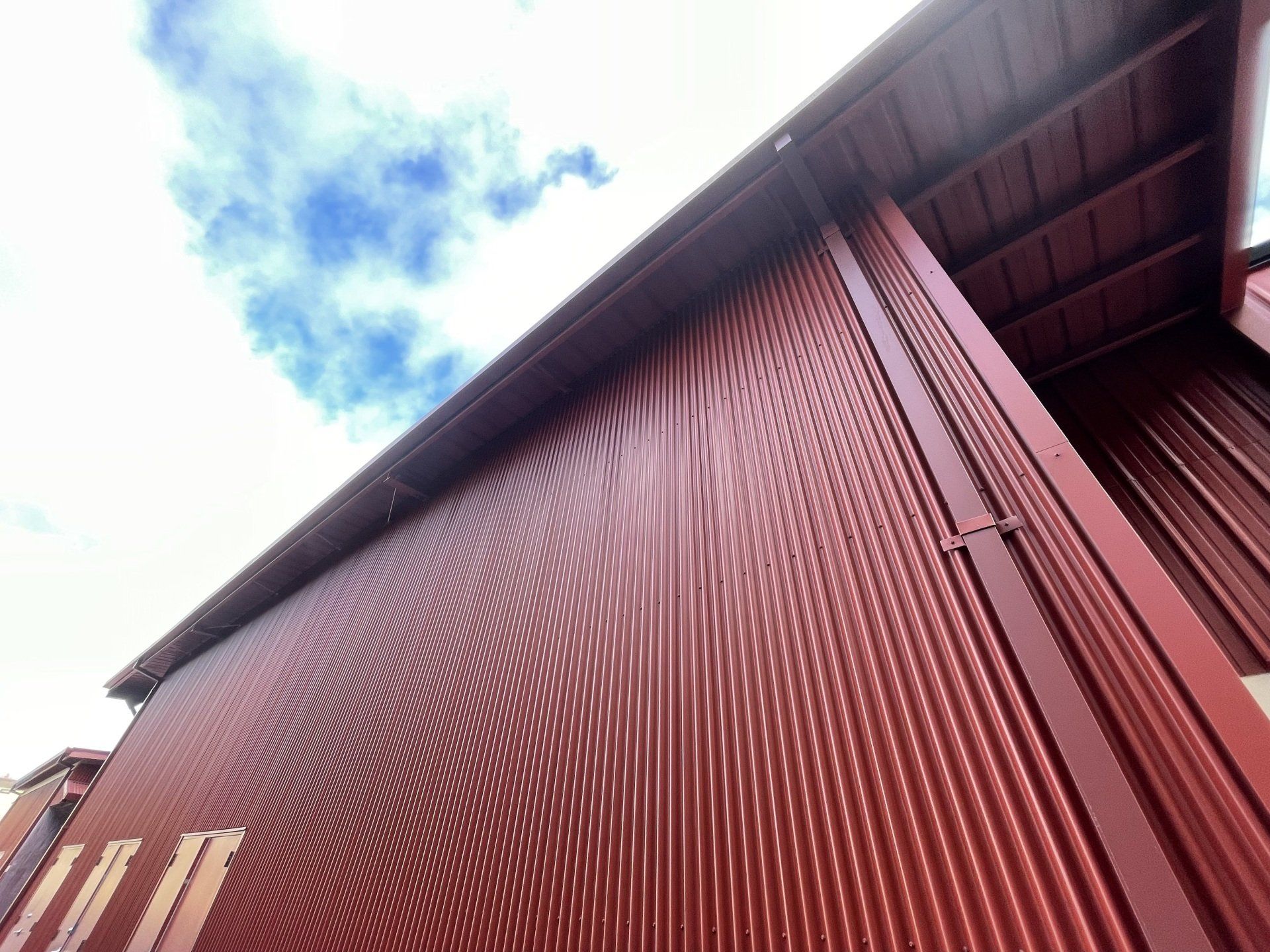 Looking up at a red building with a blue sky in the background