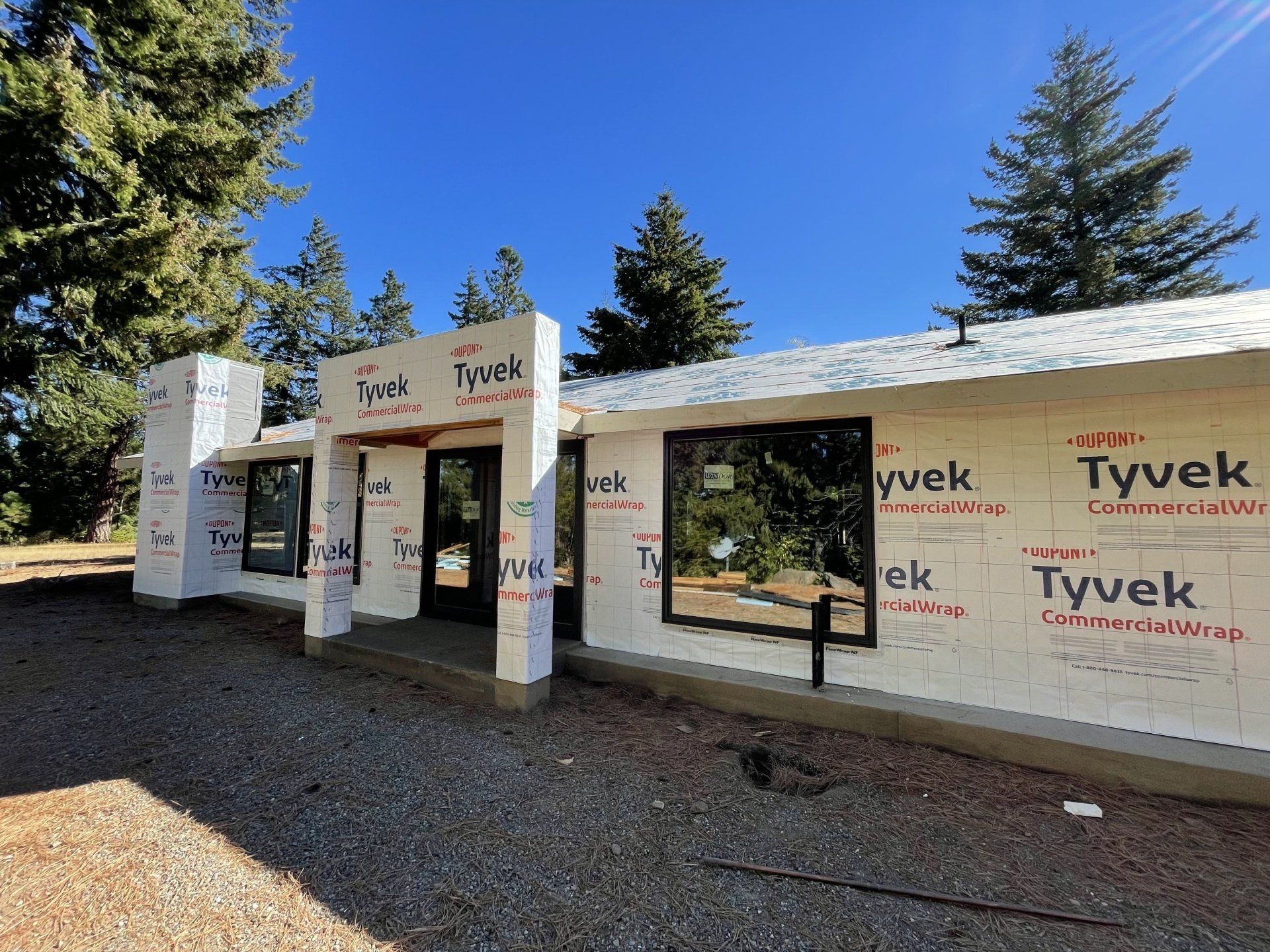 A house is being built with styrofoam and trees in the background.
