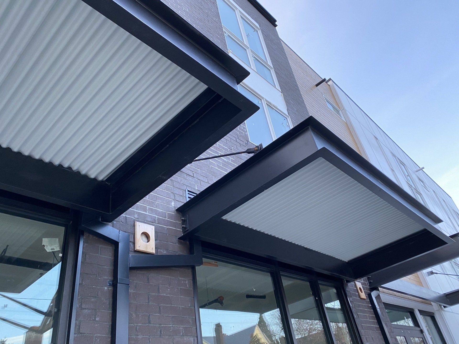Looking up at the roof of a building with a canopy over it.