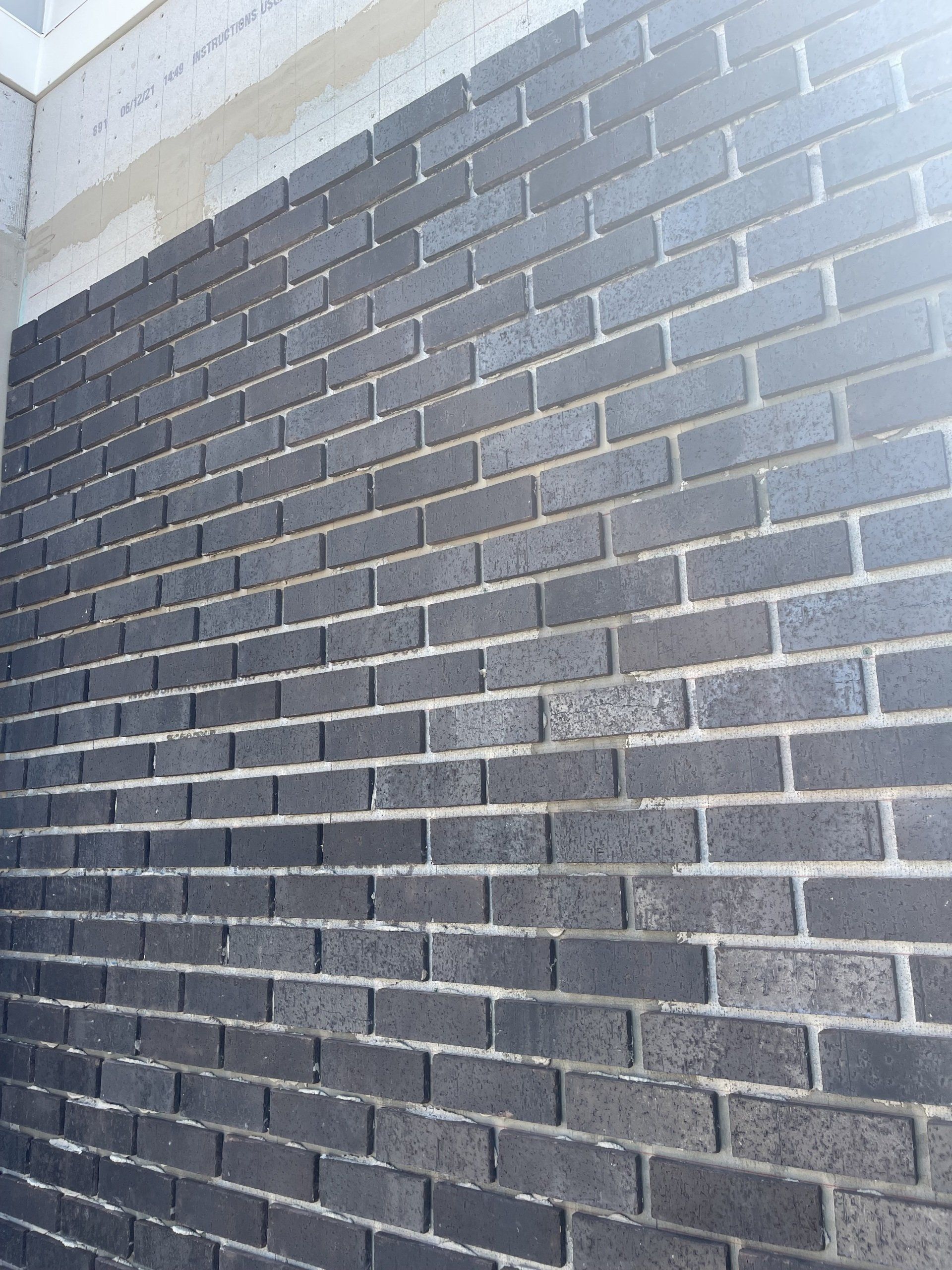 A close up of a black brick wall