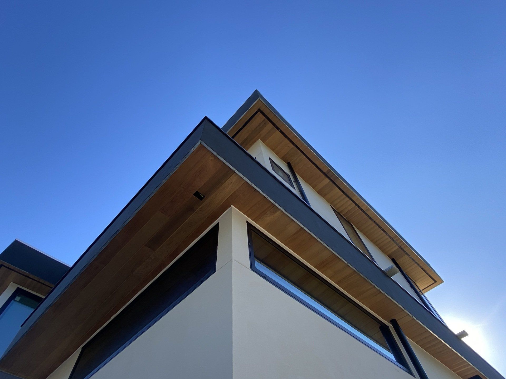 Looking up at a house with a blue sky in the background