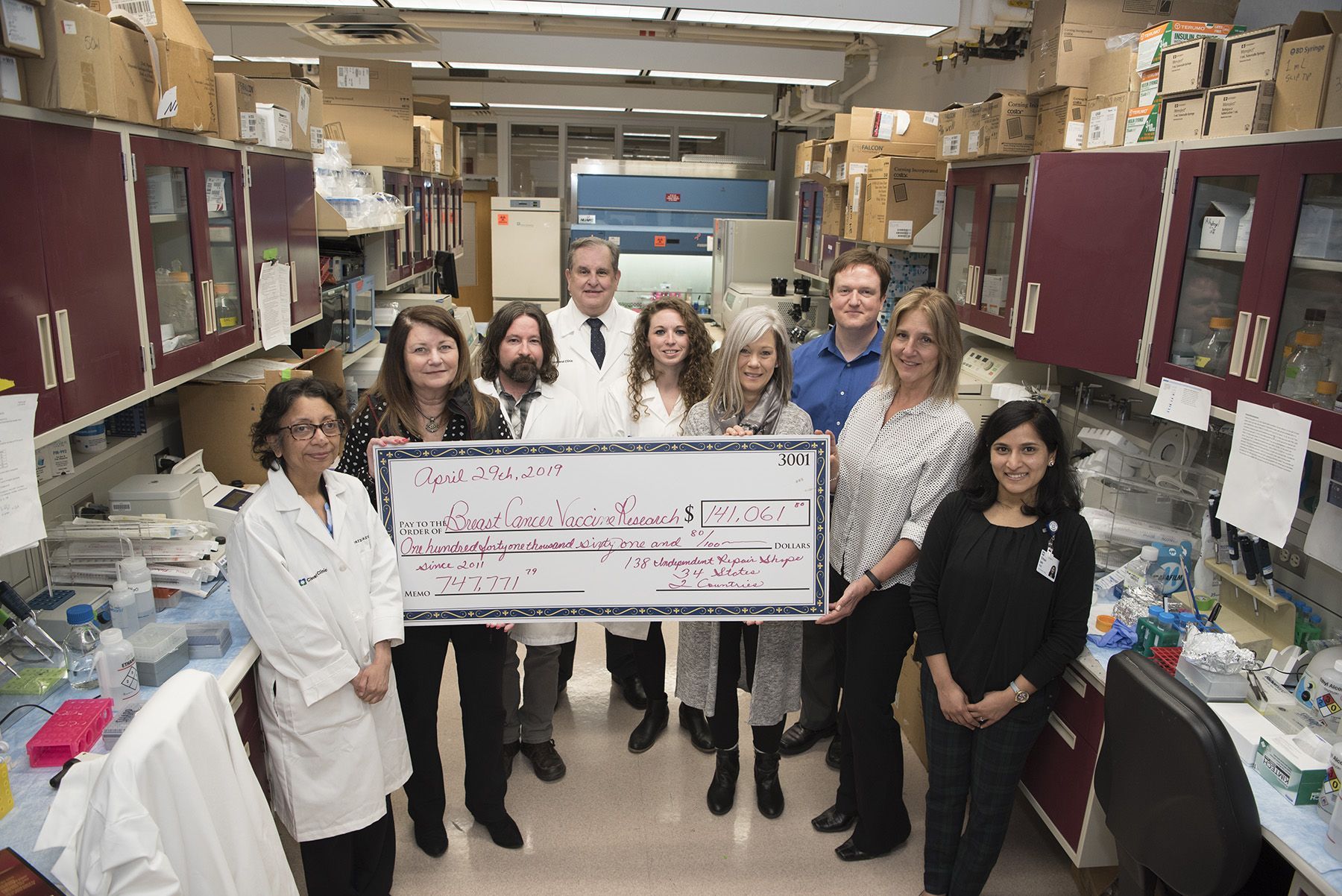 Research team posed around large check at 2018 Check Presentation for Cleveland Clinic | Brakes For Breasts