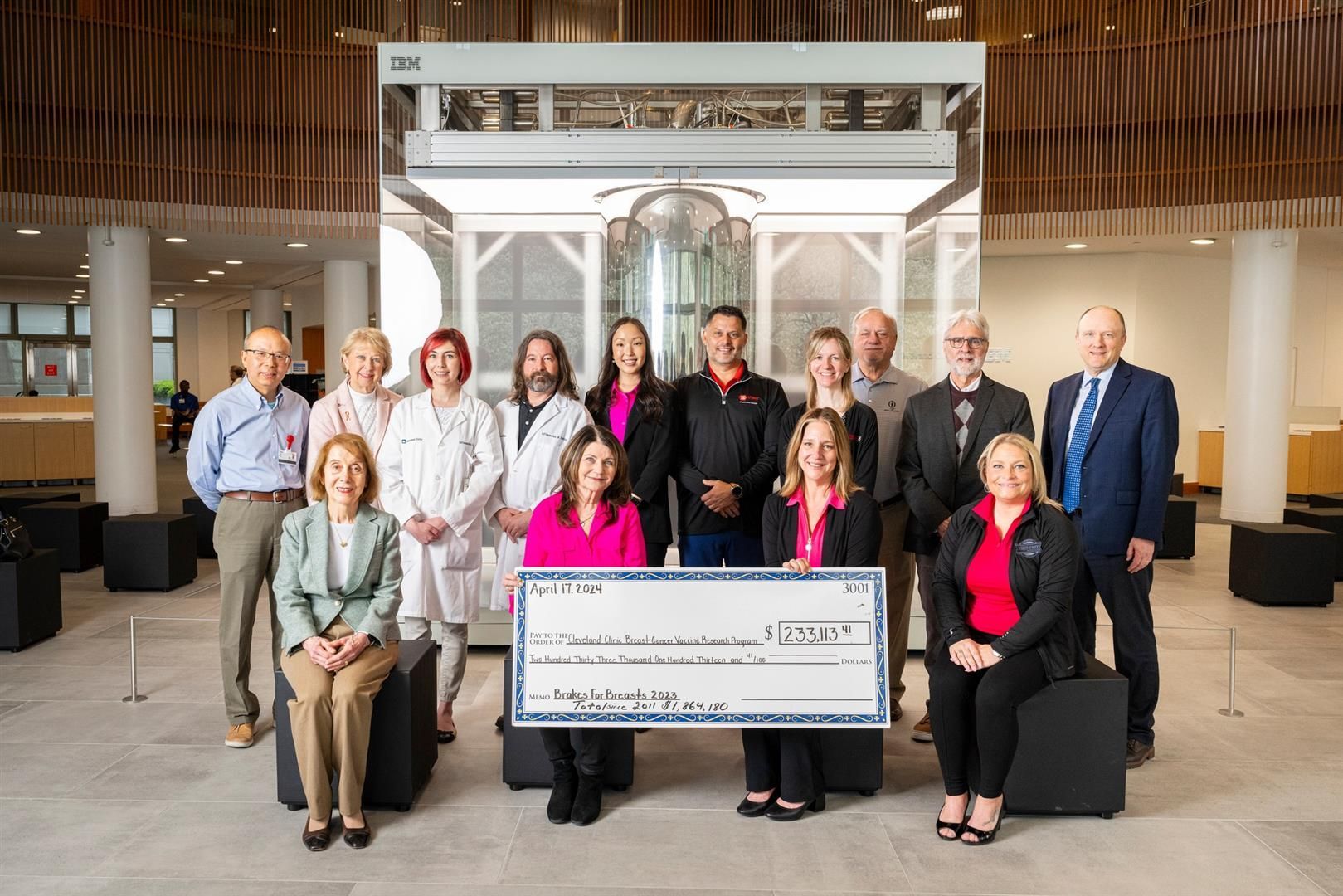 Research team posed around large check at 2023 Check Presentation | Brakes For Breasts