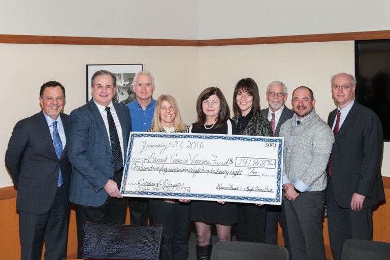 Participating shops join with Dr. Tuohy and his research team in receiving a check | Brakes For Breasts