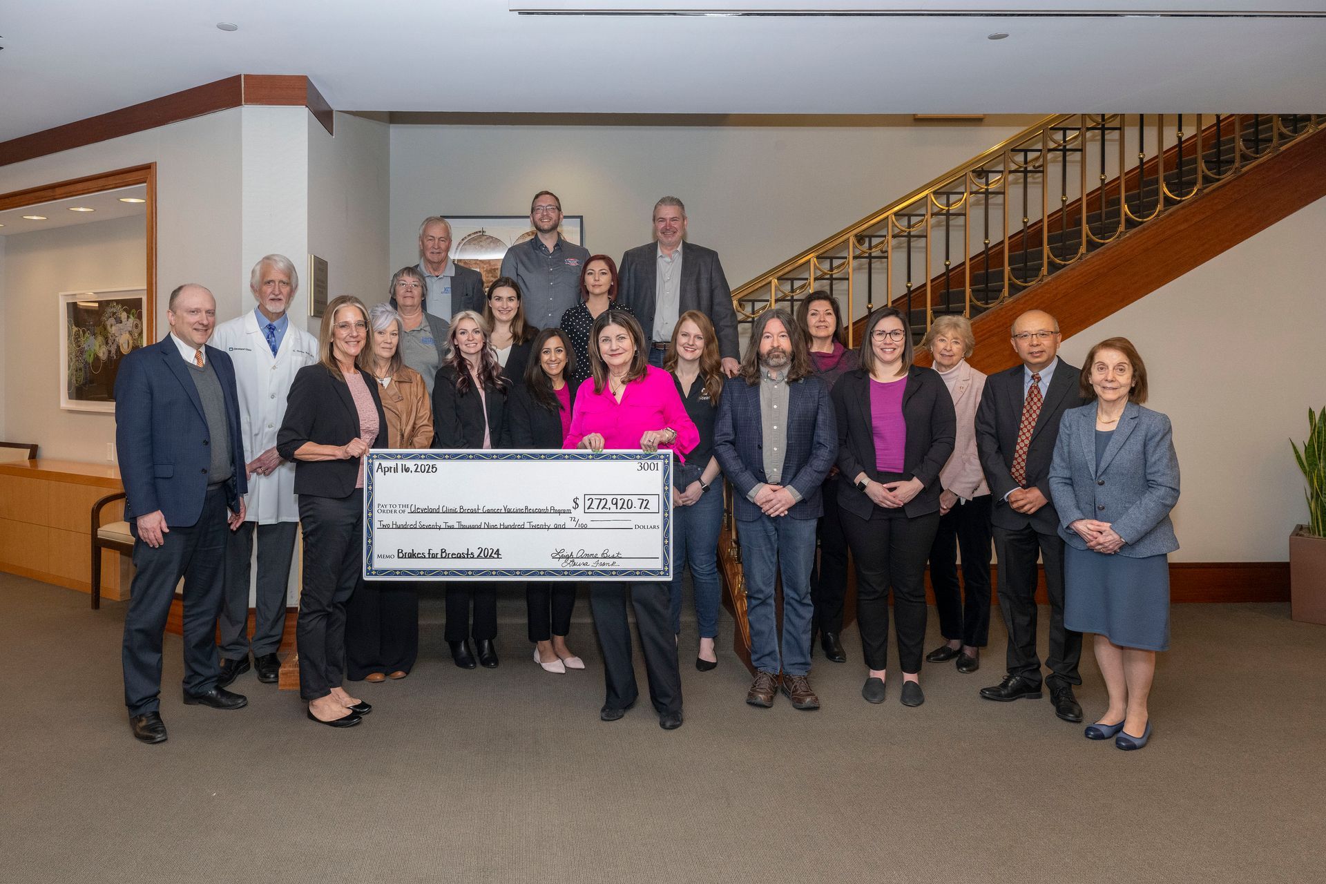 Research team posed around large check at 2023 Check Presentation | Brakes For Breasts