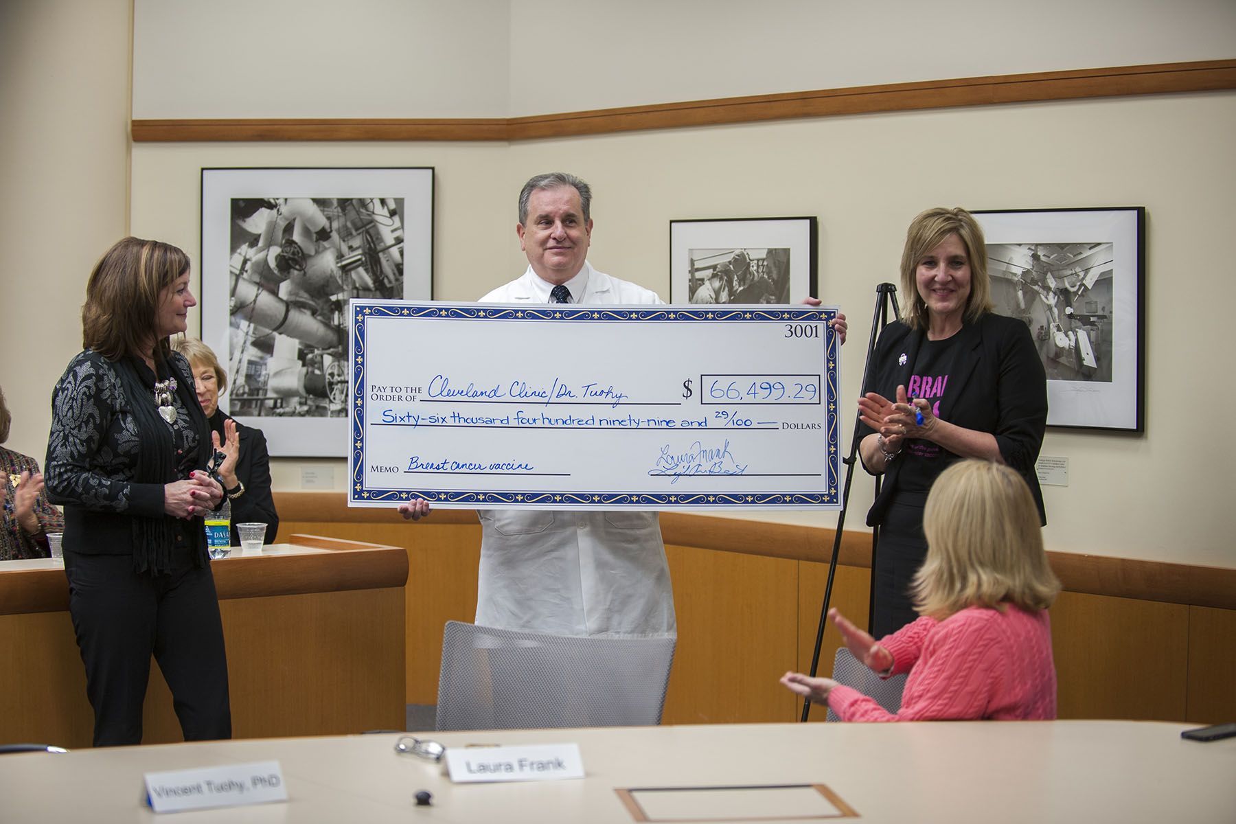 Dr. Tuohy holding large check at presentation | Brakes For Breasts