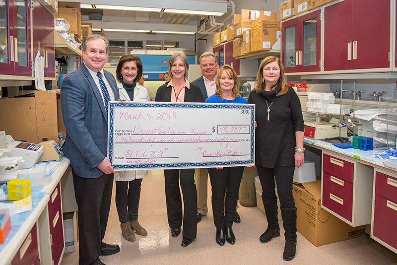 Dr. Tuohy and group with large check in 2018 for Breast Cancer Vaccine Fund | Brakes For Breasts