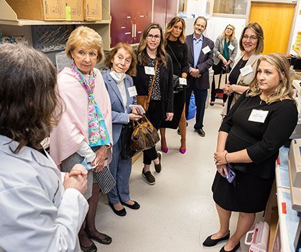 Research team discussing with group | Brakes For Breasts