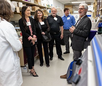 Research team discussing with group | Brakes For Breasts