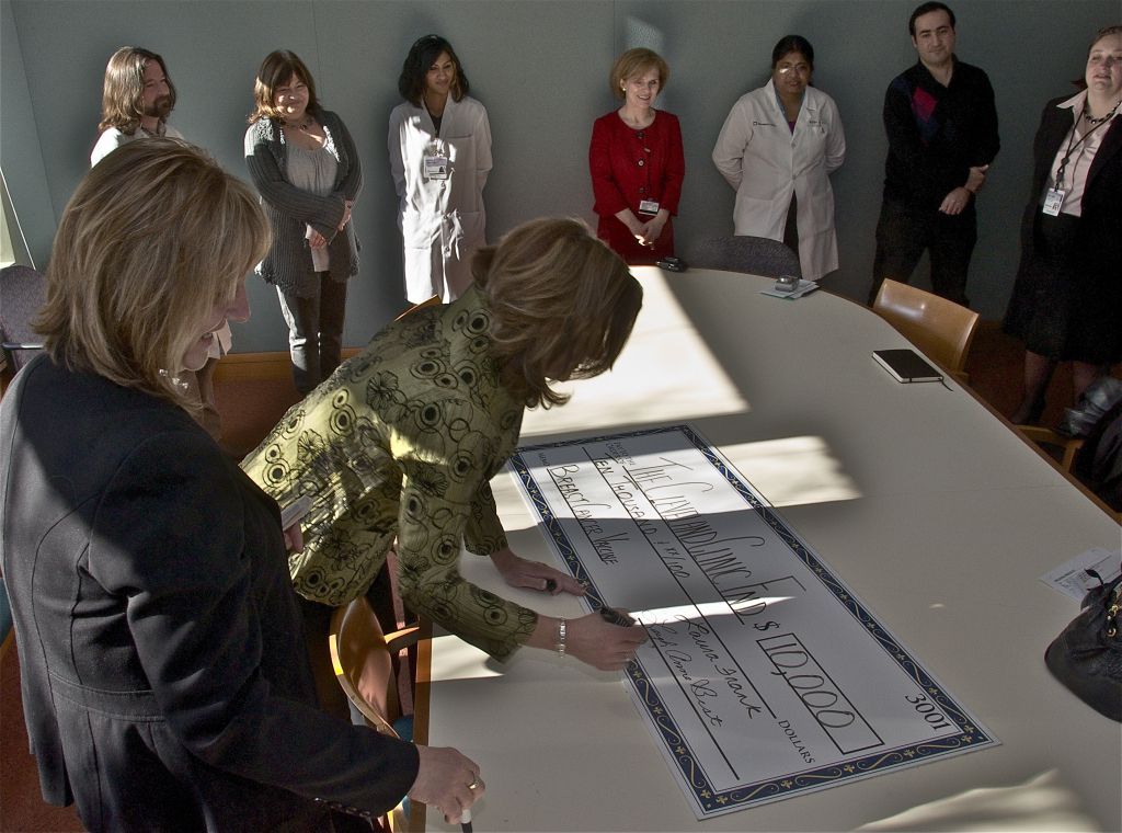 Signing large check at 2011 Check Presentation for Cleveland Clinic | Brakes For Breasts