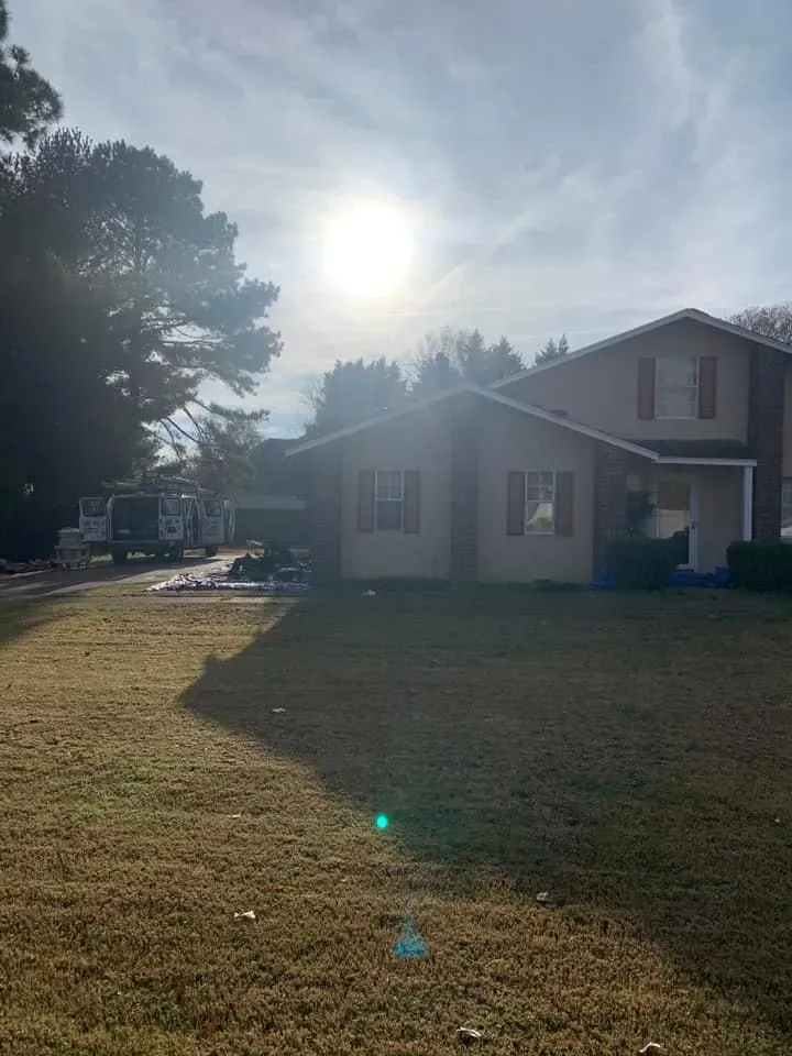 Trucks Parked Beside House — West TN — Mark’s Roofing Company