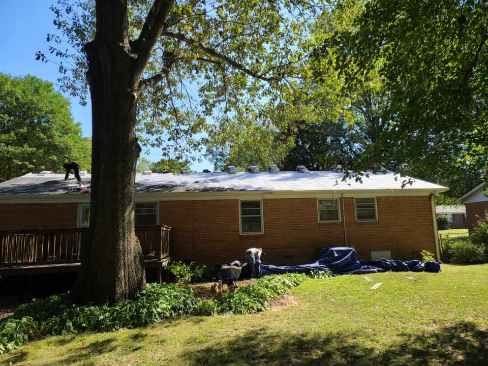 Working On Roof Of Brick House — West TN — Mark’s Roofing Company