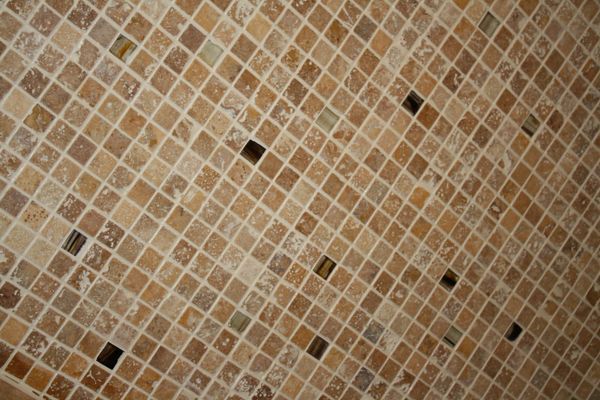 A close up of a tiled floor with a pattern of squares.