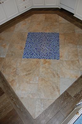 A kitchen floor with a blue square in the middle.