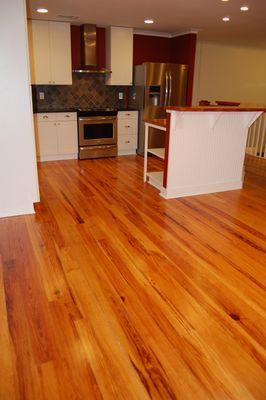 A kitchen with hardwood floors and stainless steel appliances