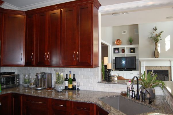 A kitchen with wooden cabinets and granite counter tops