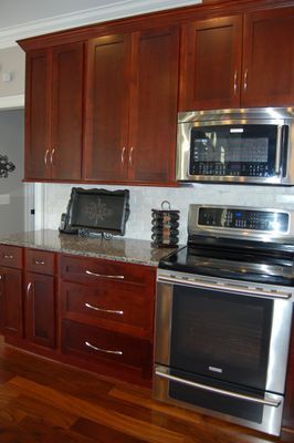 A kitchen with stainless steel appliances and wooden cabinets