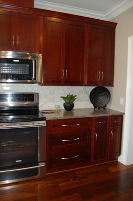 A kitchen with stainless steel appliances and wooden cabinets.