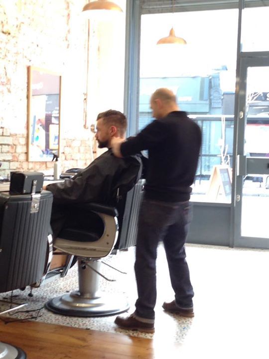 Em cuts clients hair at Em's Barbershop, Stroud Green, N4 London