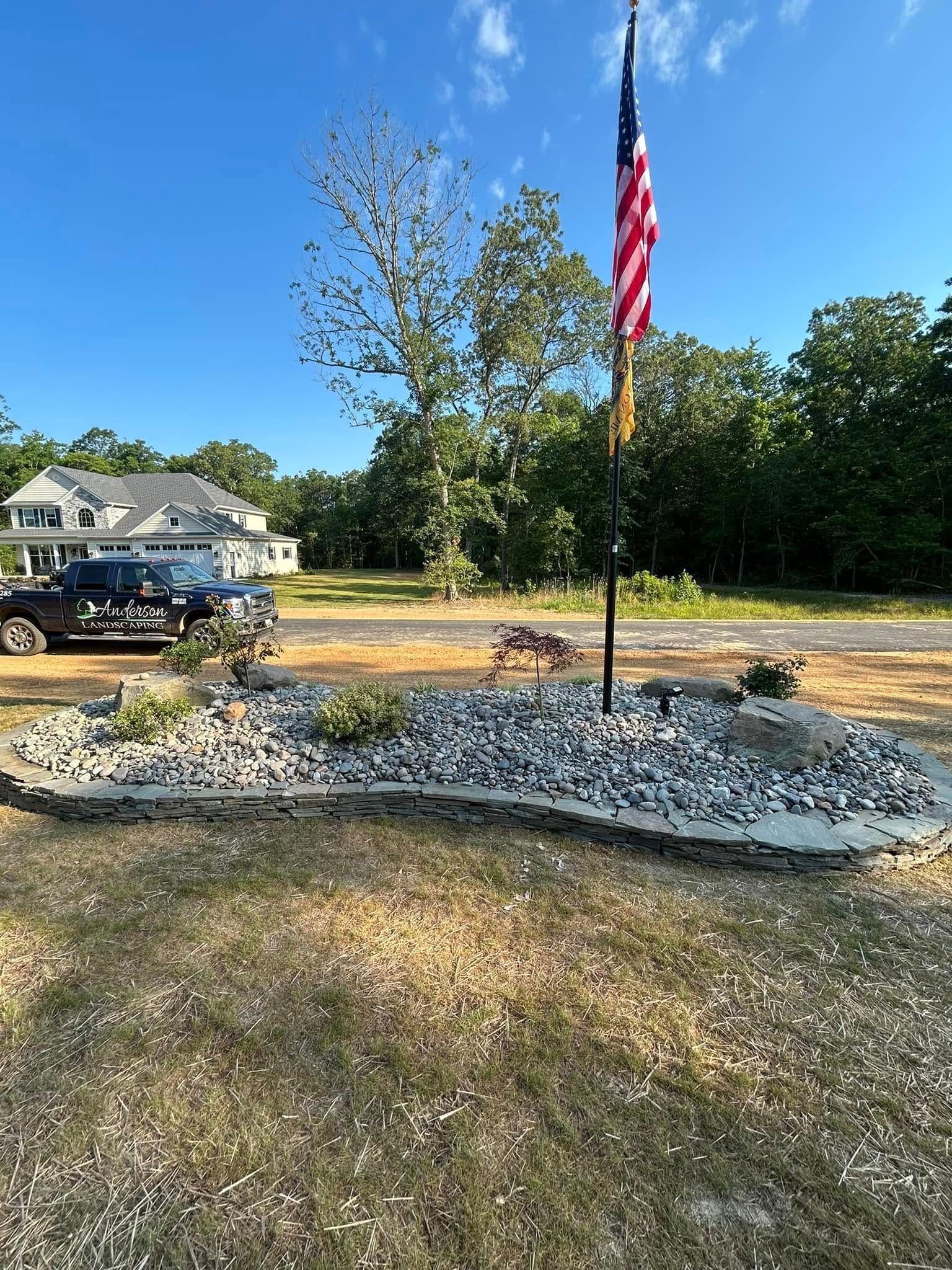 An american flag is flying in front of a house.