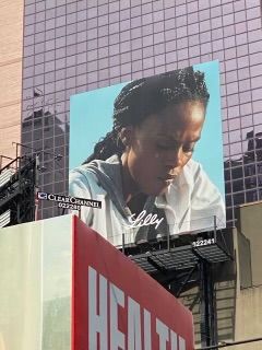 Chaunte Lowe on billboard in partnership with Olympic Partner Eli Lilly