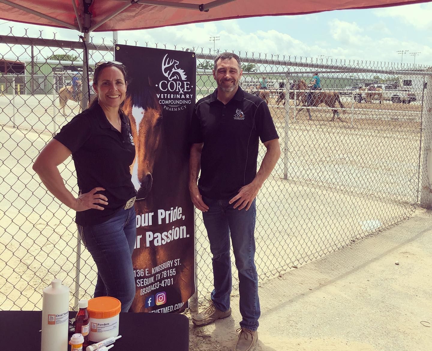 A man and a woman standing next to a sign that says our pride our passion