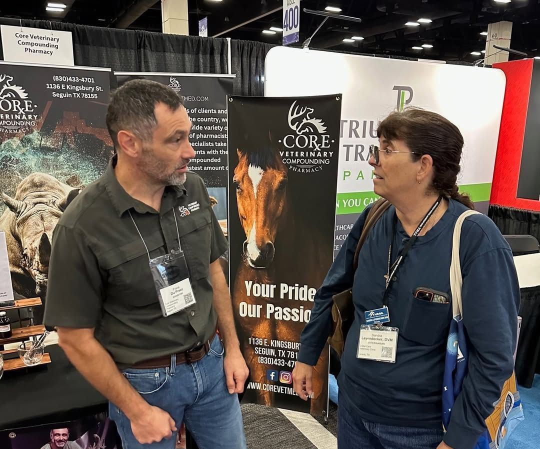 A man and a woman are talking in front of a sign that says your pride our passion