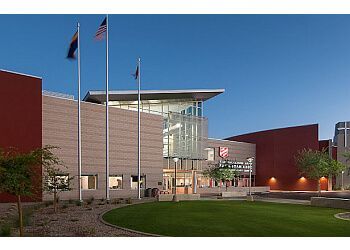A large building with flags flying in front of it