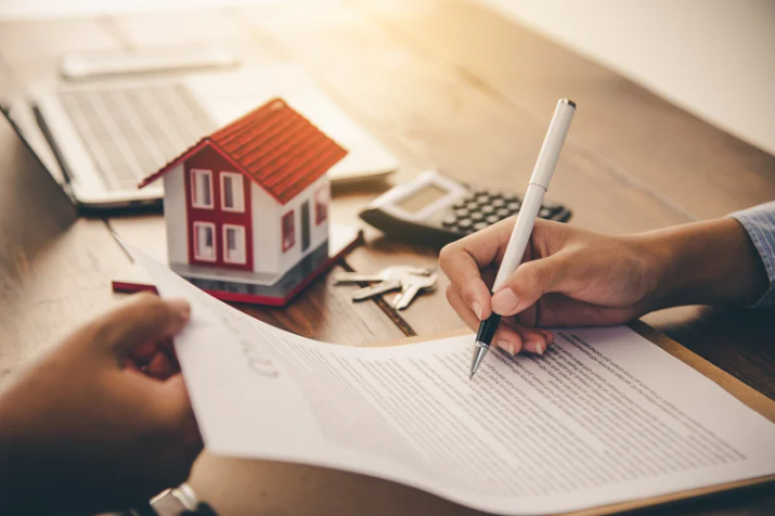 A person is writing on a piece of paper with a pen.