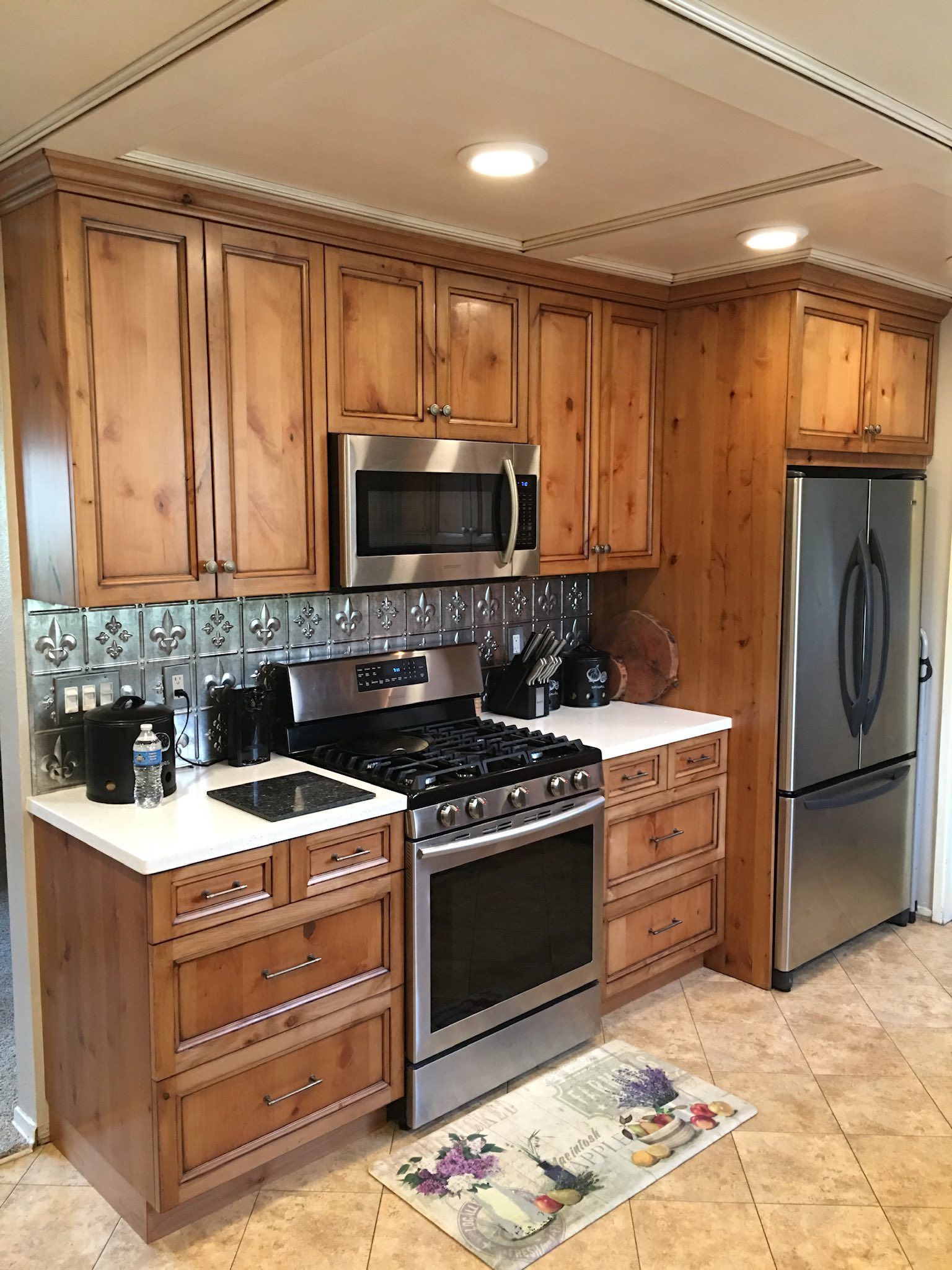 Kitchen with wood cabinets, stainless steel appliances, and a tiled backsplash.