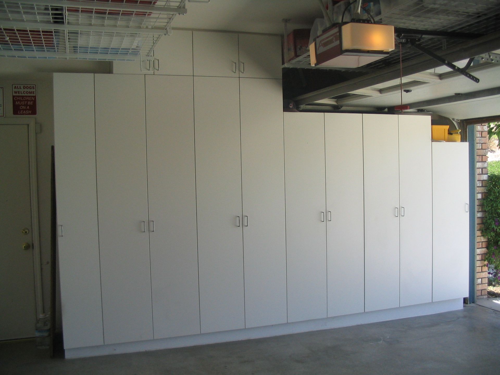 White storage cabinets in a garage.