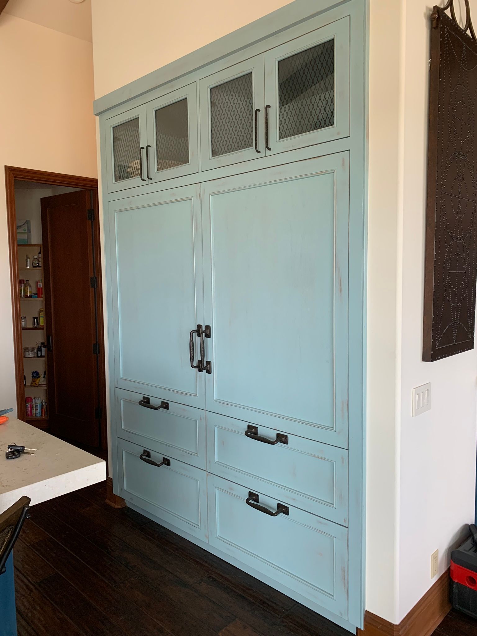 Light blue built-in storage cabinet.