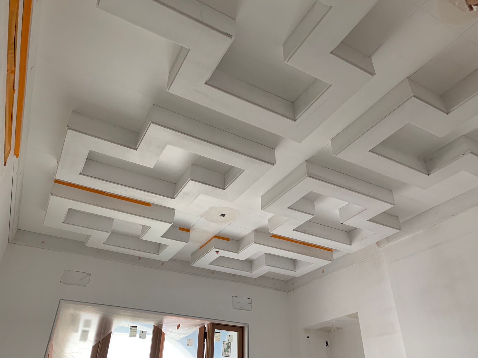 White geometric recessed ceiling design.