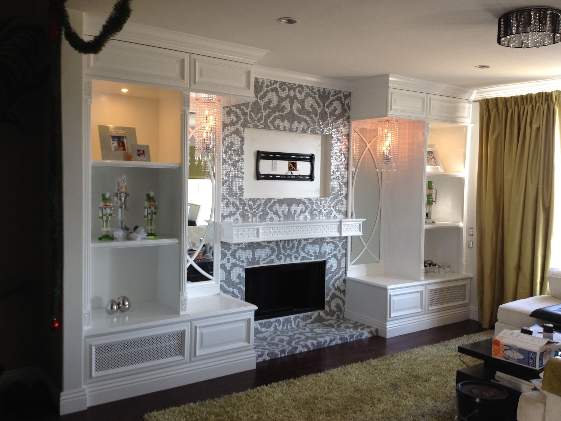 Living room with white built-ins flanking a fireplace.  