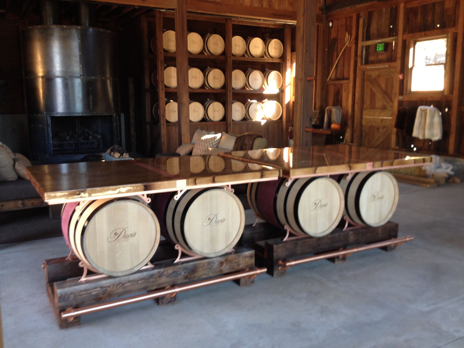 Wooden bar made with barrels in a rustic setting, copper details.
