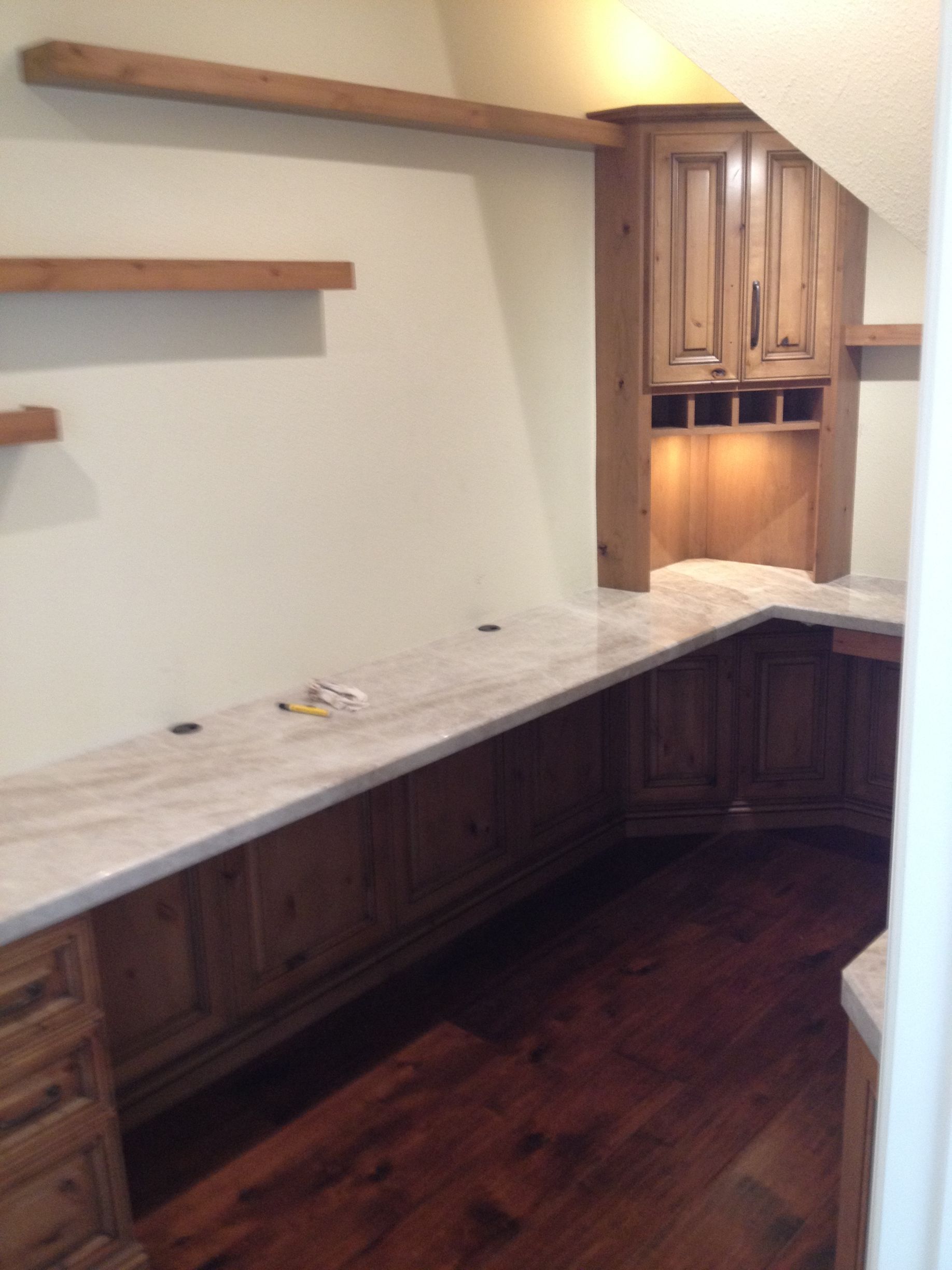 Built-in office space with wooden cabinets, countertops, and hardwood floors.