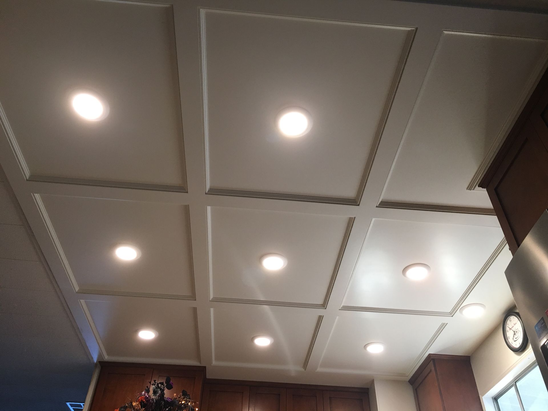 White coffered ceiling with recessed lights.