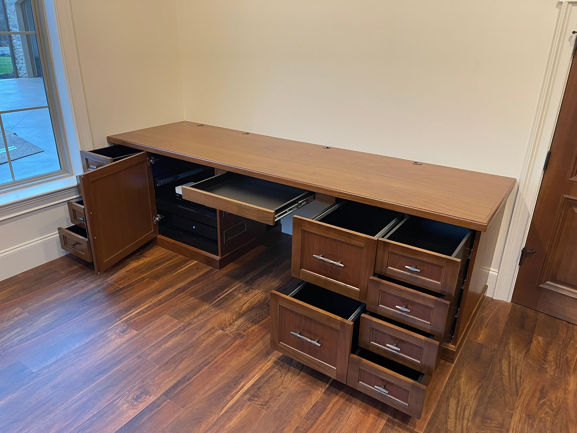 Wooden desk with multiple drawers and a keyboard tray.
