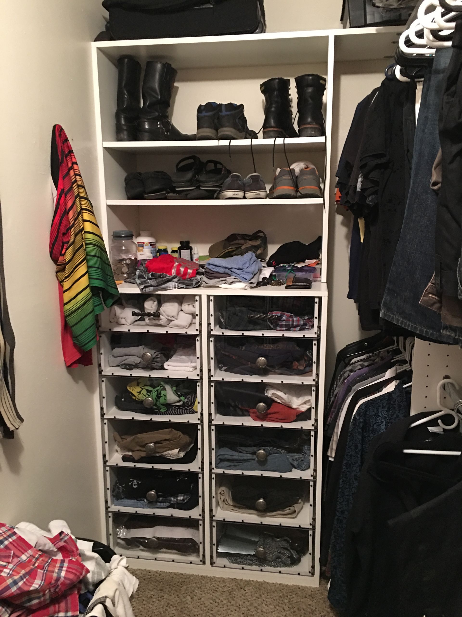Closet with shelves and shoe organizers. Shoes and clothing are neatly arranged.