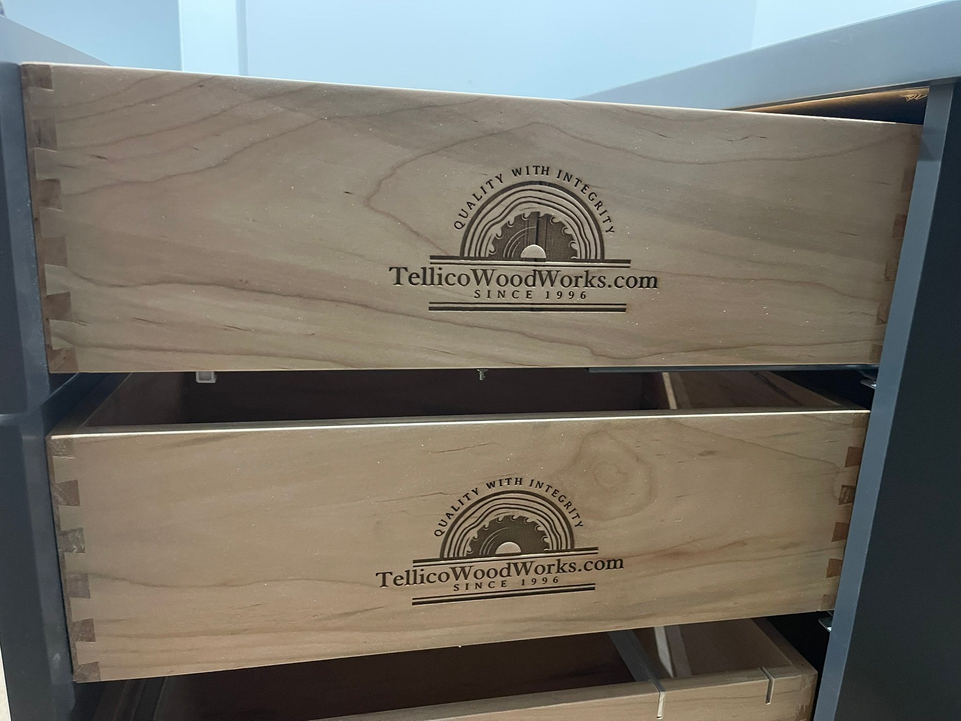 Wooden drawers with dovetail joints, labeled with 