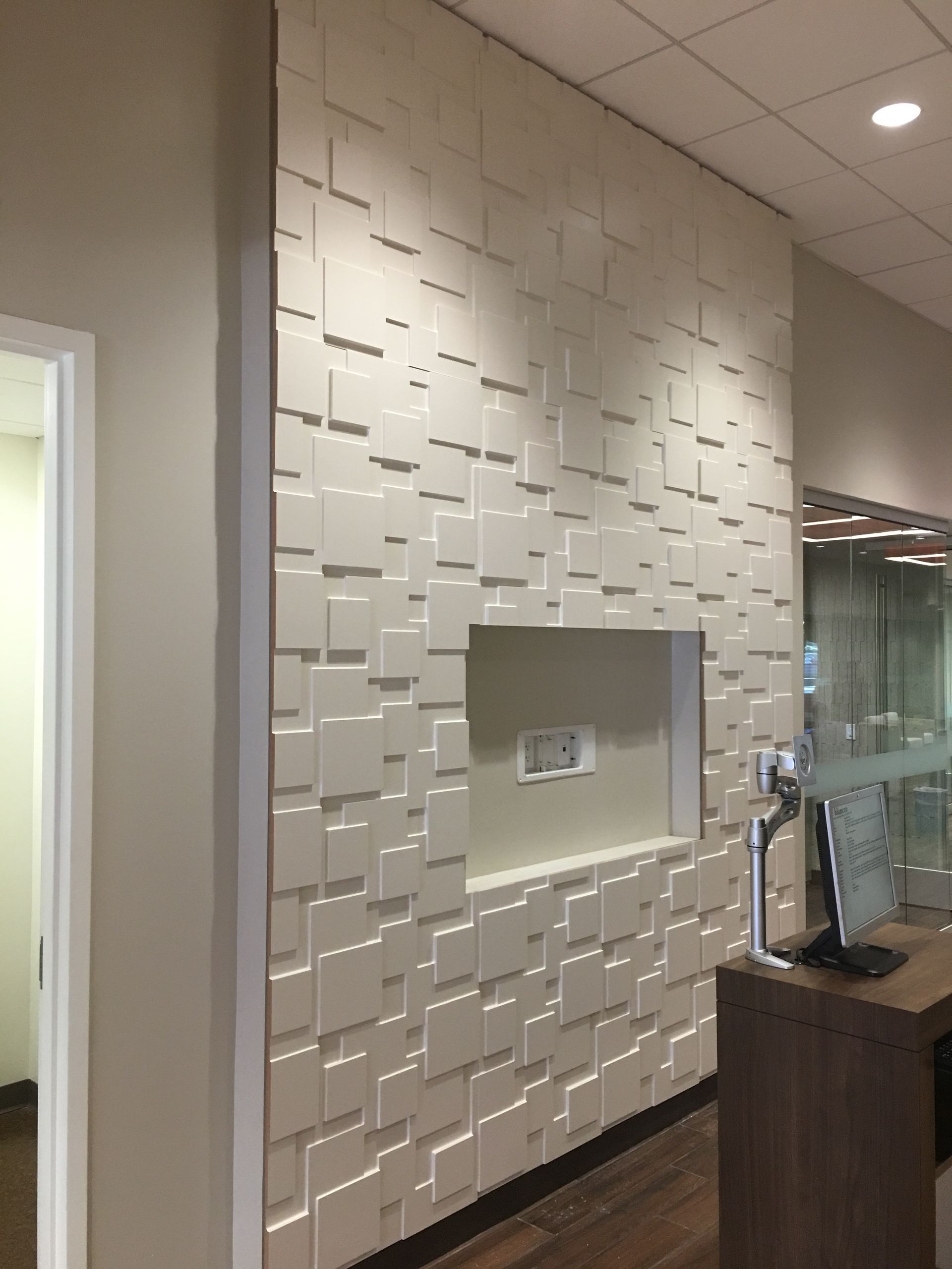 Wooden cabinetry in a kitchen area with a countertop, appliances, and a small bar with seating.