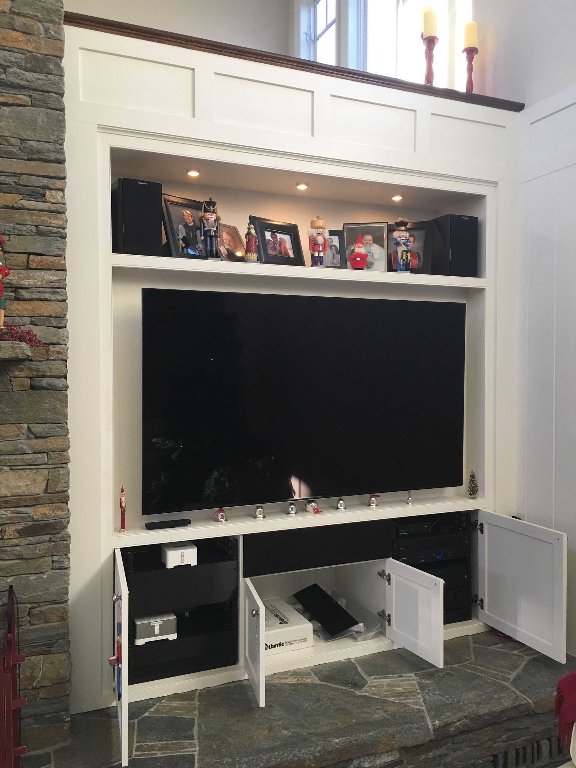 White built-in cabinet with a TV.