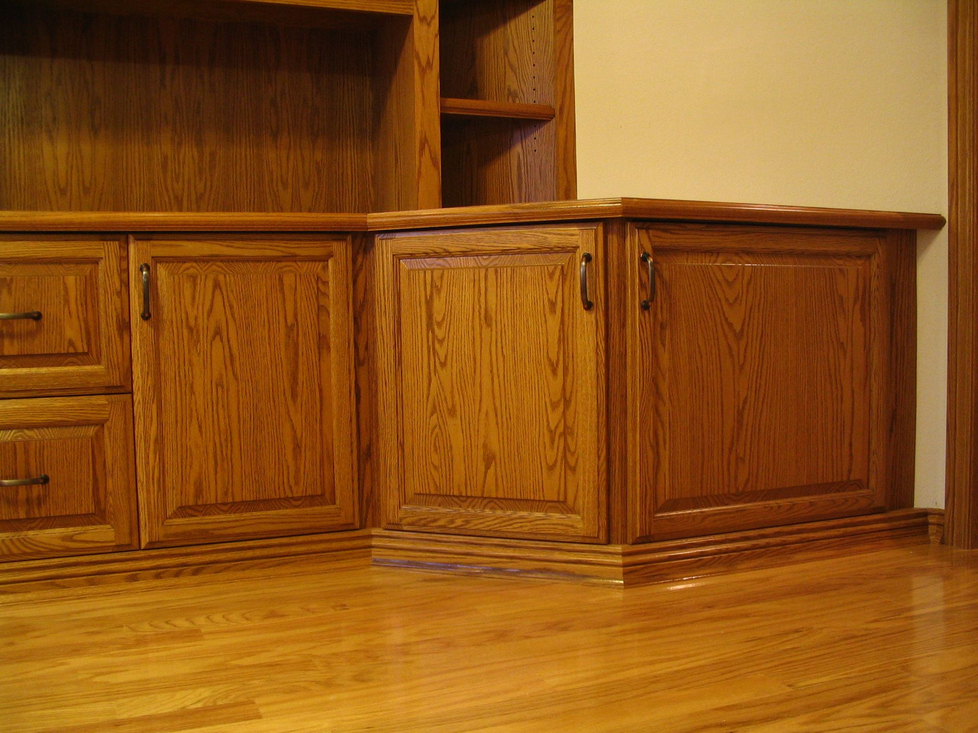 Wooden cabinets in a room, with visible wood grain and a wooden floor.