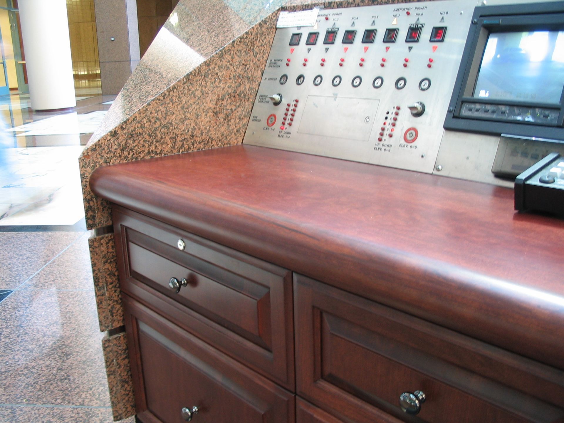 Control panel with drawers, granite accent, and wood countertop.
