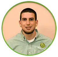 Man smiling in a light green button-down shirt inside a green circle.