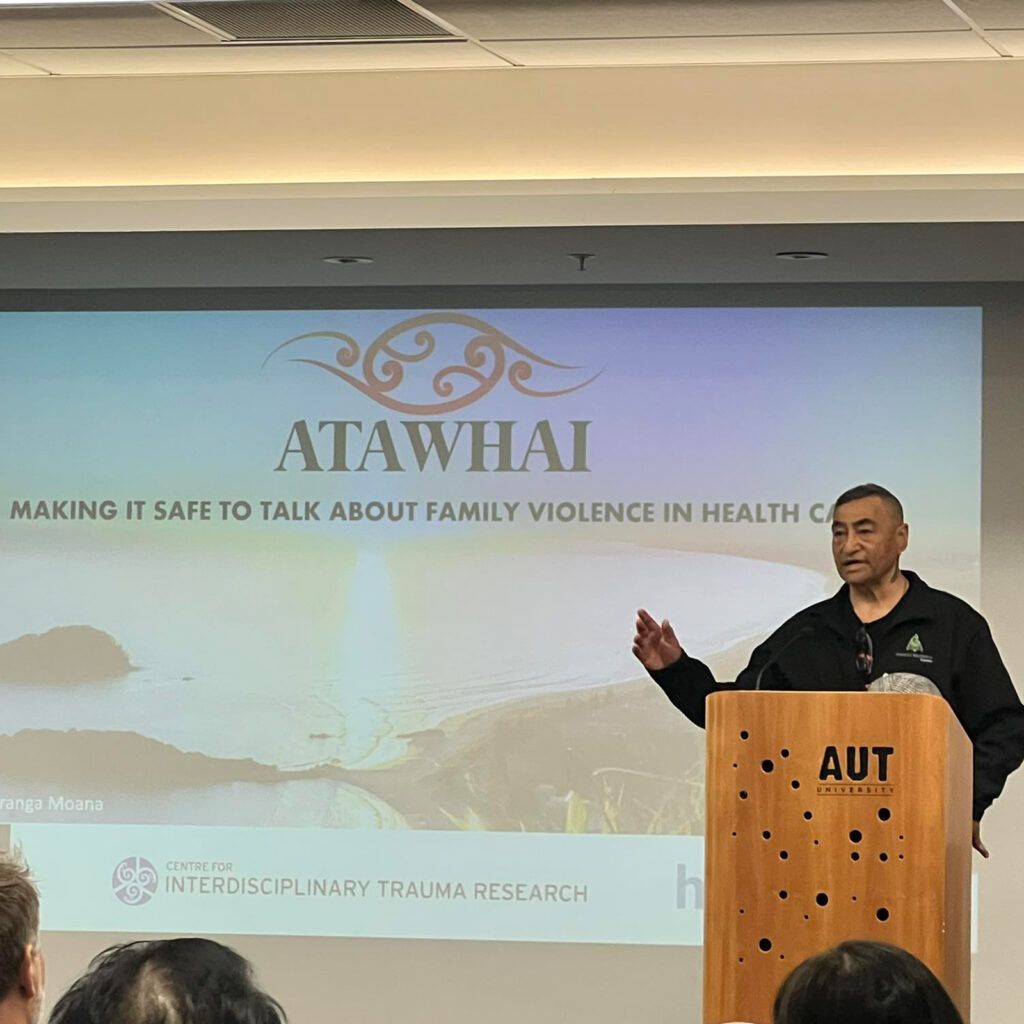 Man speaking at a podium with 